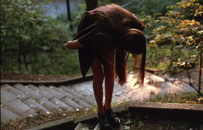 Rear view of woman standing outdoors