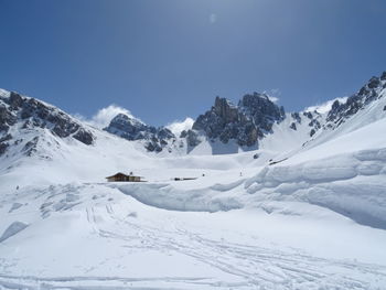 Scenic view of snow covered mountains against sky