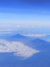 Aerial view of volcanic landscape against blue sky