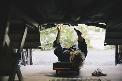 Mechanic repairing car in workshop