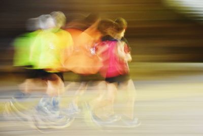 Rear view of woman running on road in city