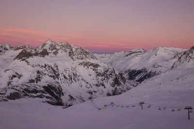 Scenic view of snowcapped mountains against sky during sunset