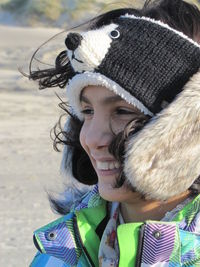 Smiling woman in fur hat looking away