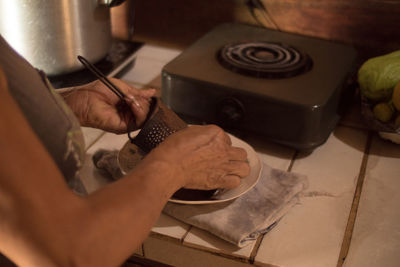 Close-up of woman grating chocolate