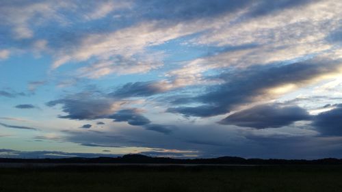 Scenic view of dramatic sky over field