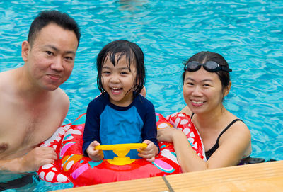 Portrait of smiling family in swimming pool