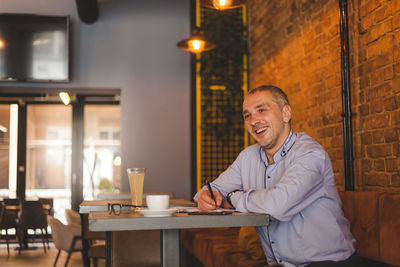 Portrait of a smiling man sitting in restaurant