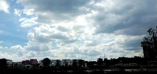 Buildings in city against cloudy sky