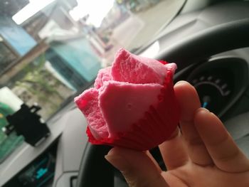 Close-up of hand holding ice cream cone