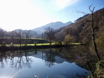 Scenic view of lake and mountains against sky