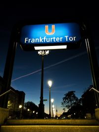 Low angle view of illuminated street light against blue sky