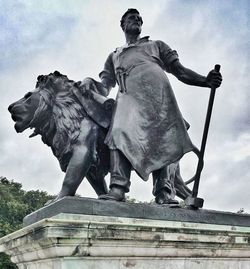 Low angle view of statue against cloudy sky