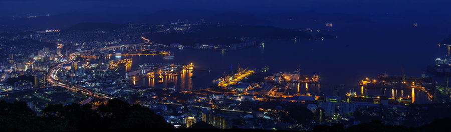 High angle view of illuminated buildings in city at night