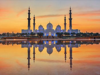 Reflection of temple in lake at sunset