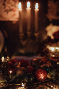 Close-up of illuminated candles on table