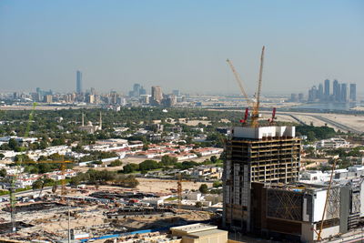 Aerial view of buildings against sky in city