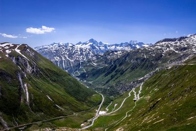 Scenic view of mountains against blue sky during winter