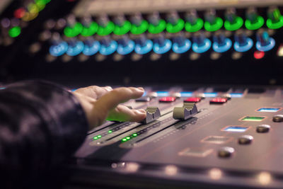 Cropped hand mixing music in recording studio