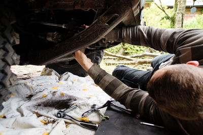 Man repairing car at garage