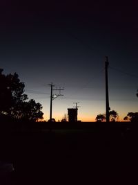 Silhouette electricity pylon against sky during sunset