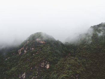 Scenic view of mountains against sky during rainy season