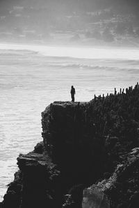 Man looking at sea against sky