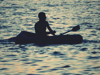 Silhouette man in sea