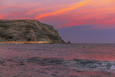 Scenic view of sea against orange sky