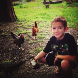 Boy sitting on a land