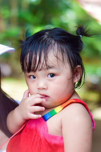 Close-up of cute girl looking away