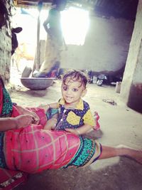 Portrait of smiling girl sitting outdoors