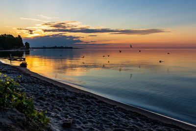 Scenic view of beach against sky during sunset