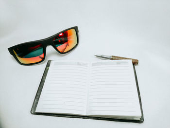 Close-up of sunglasses on table against white background