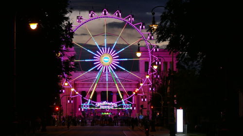 Illuminated ferris wheel at night