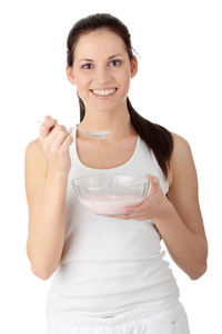 Portrait of a smiling young woman over white background