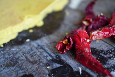 Close-up of red chili peppers on wood