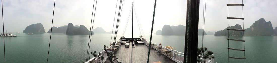 Panoramic view of boats moored in sea against sky