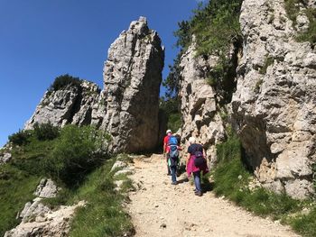 Rear view of people walking on mountain