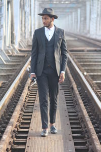 Full length of man standing at railroad station