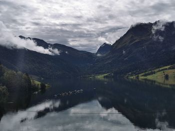 Scenic view of lake and mountains against sky