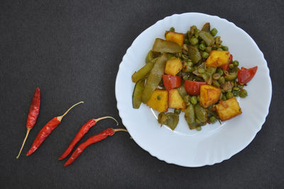 High angle view of chopped vegetables in plate on table