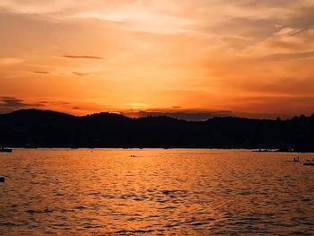 Scenic view of lake against romantic sky at sunset