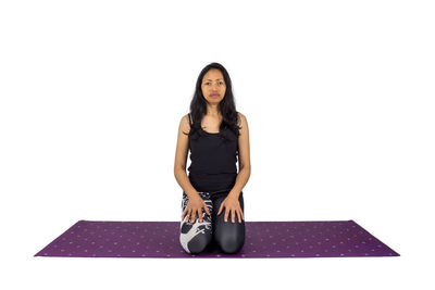 Portrait of a smiling young woman against white background