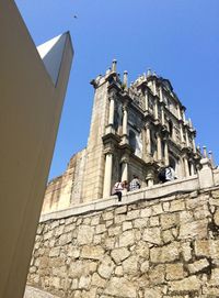Low angle view of statue against blue sky
