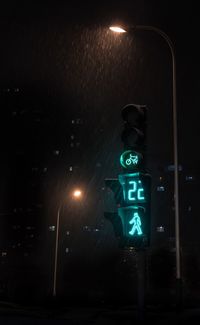 Illuminated road sign at night