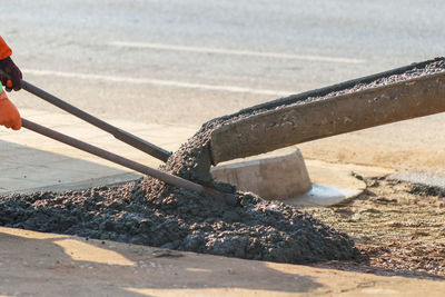 Close-up of person working on metal