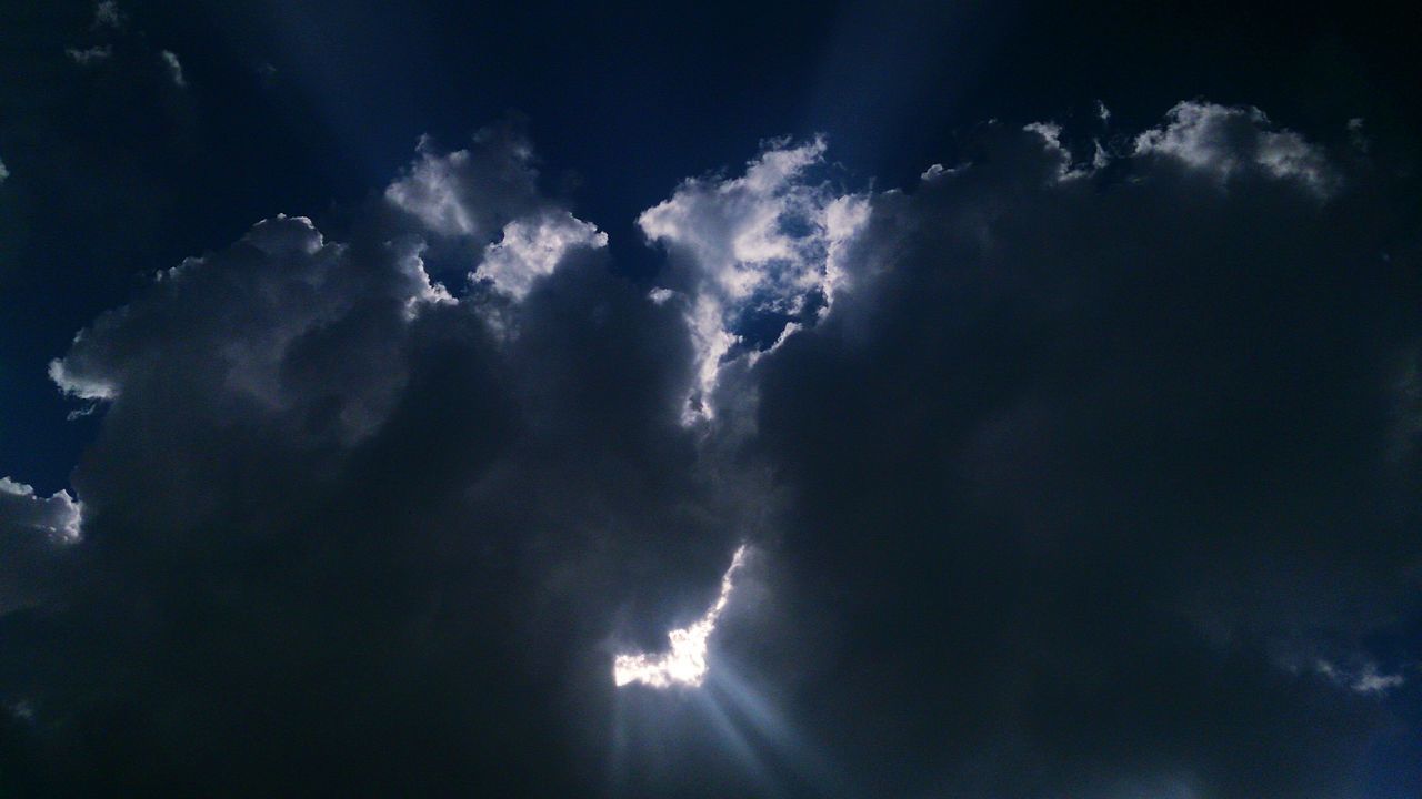 low angle view, sky, cloud - sky, beauty in nature, blue, scenics, nature, tranquility, sunbeam, tranquil scene, cloudy, sun, sunlight, cloud, idyllic, sky only, outdoors, lens flare, silhouette, no people