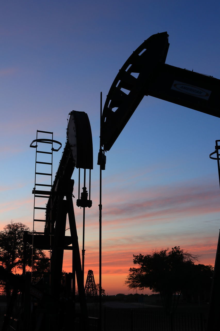 LOW ANGLE VIEW OF SILHOUETTE CRANE AGAINST ORANGE SKY