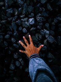 Close-up of human hand against black background