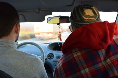 Rear view of people sitting in car